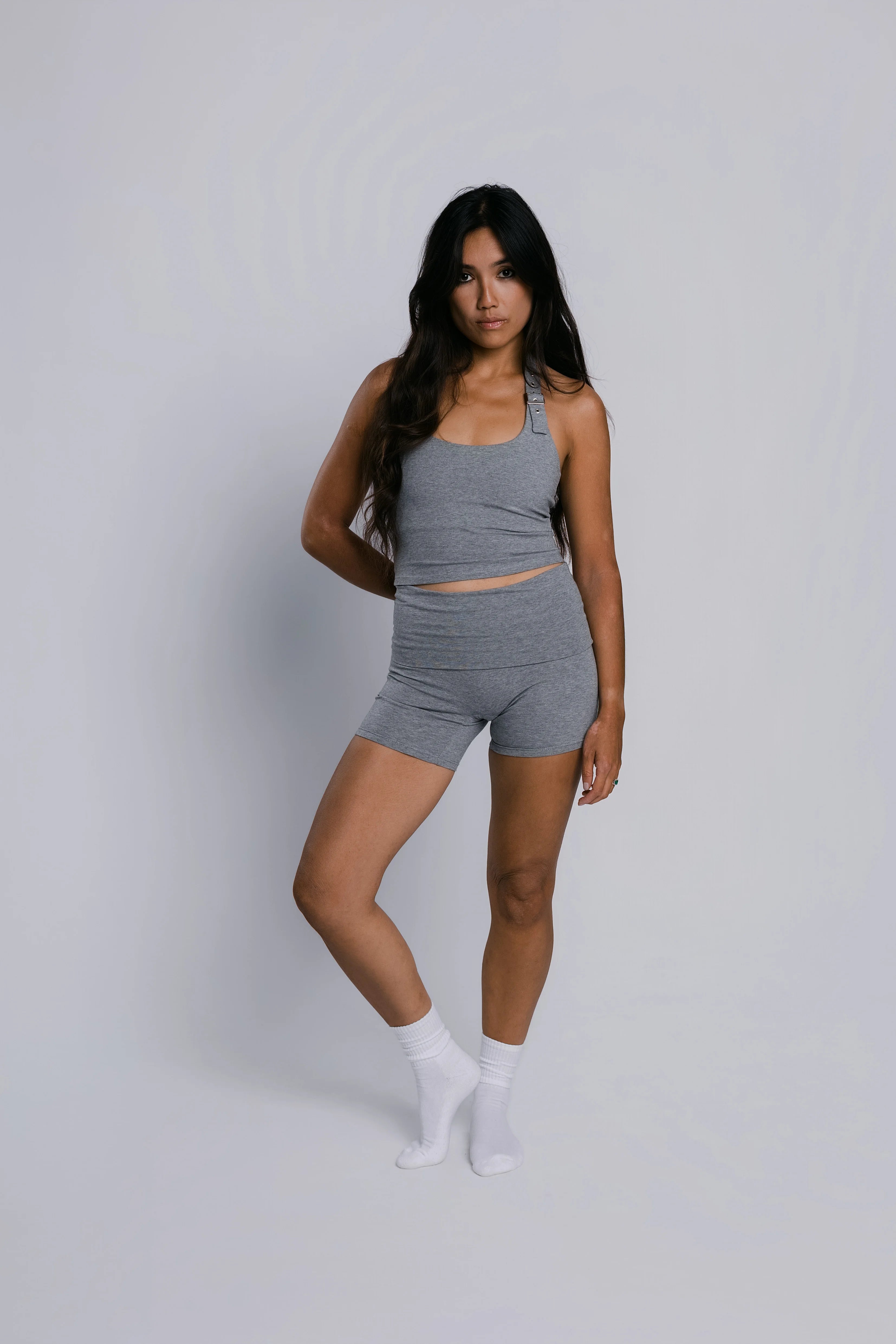 Model wearing the Billy Loop Sculpt Top in grey, front view.