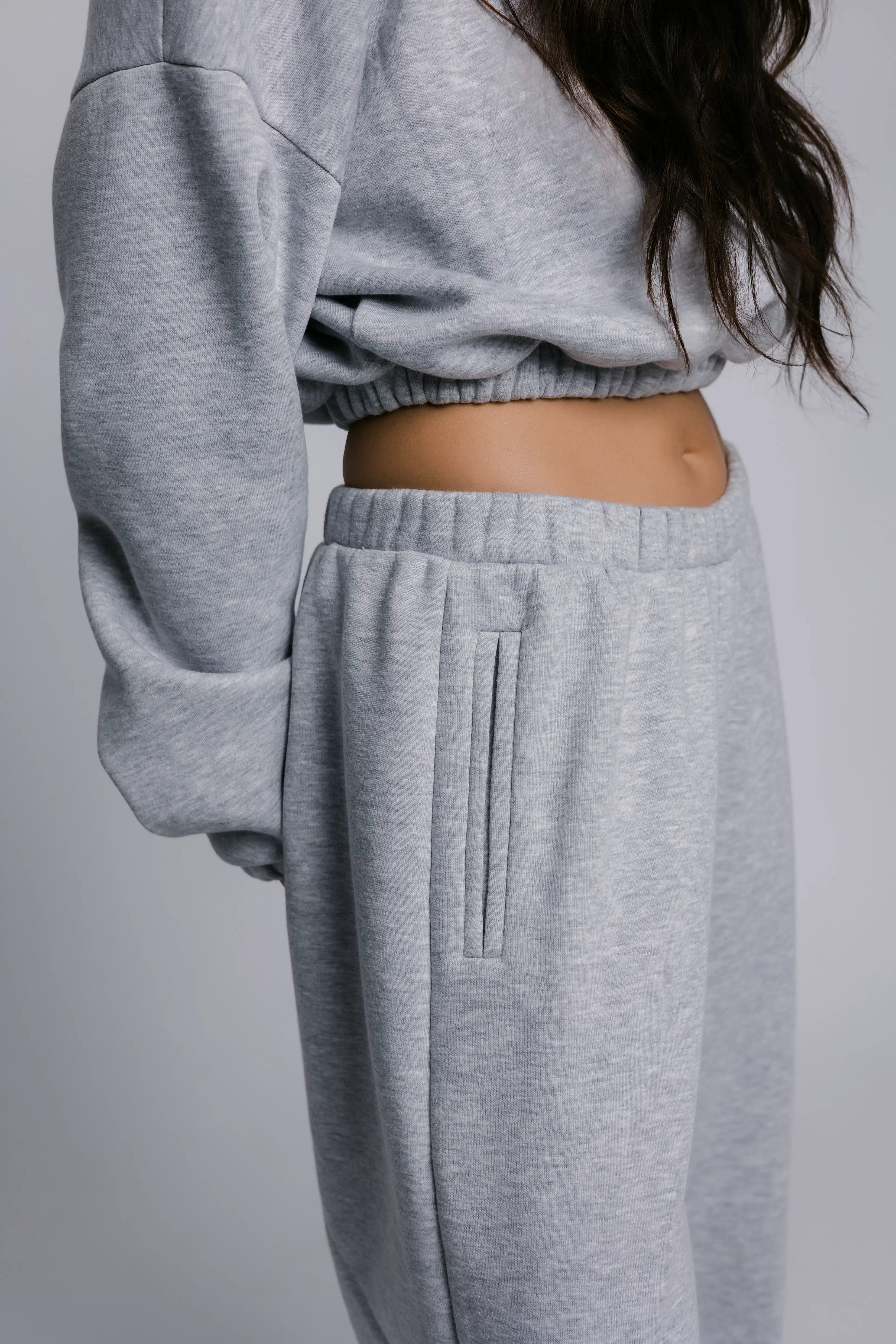 Model wearing the Billy Off-Duty Sweatpant in grey, three-quarter view.