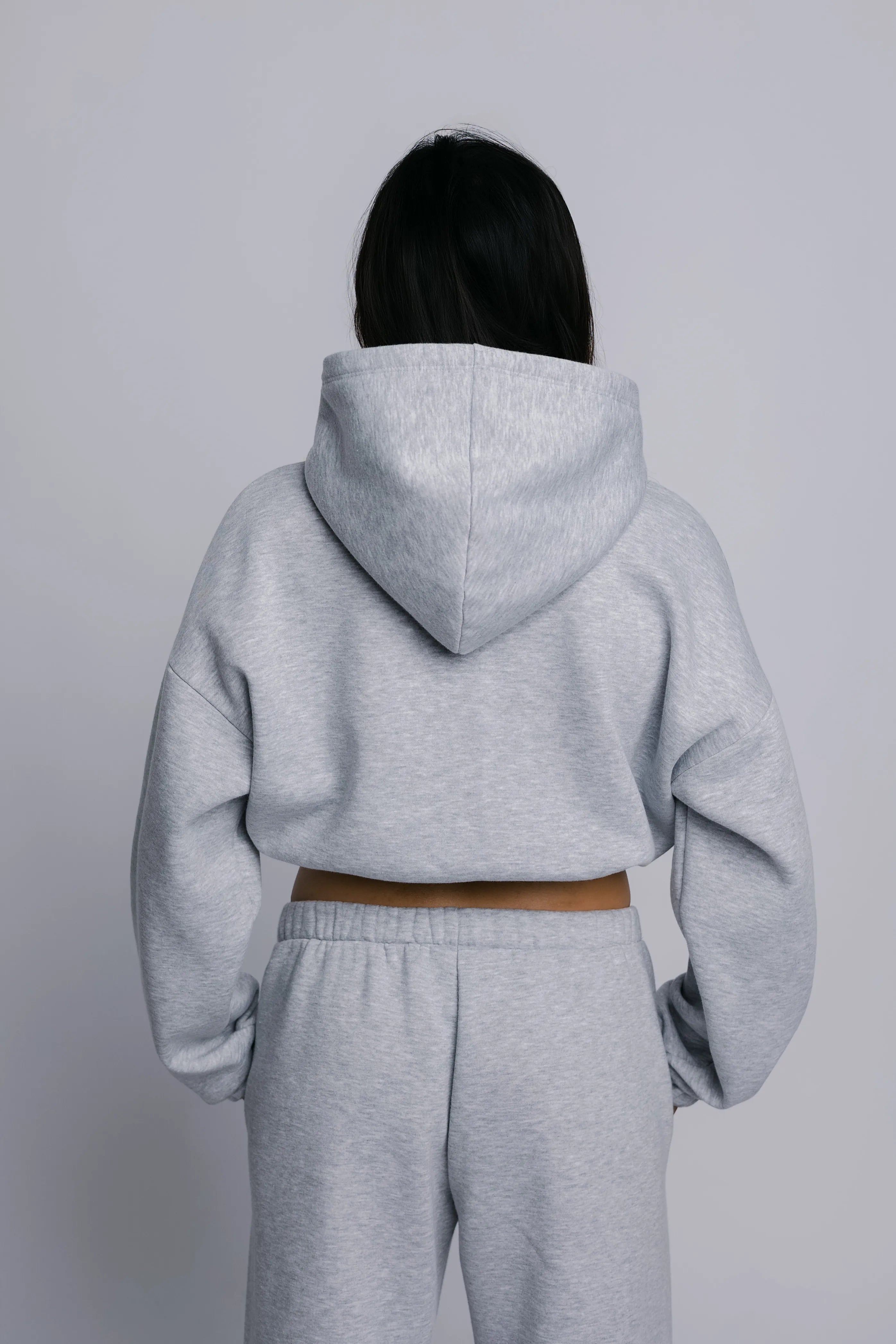 Model wearing the Billy Off-Duty Sweat in grey, back view.