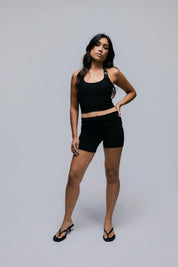 Model wearing the Billy Loop Sculpt Top in black, front view.