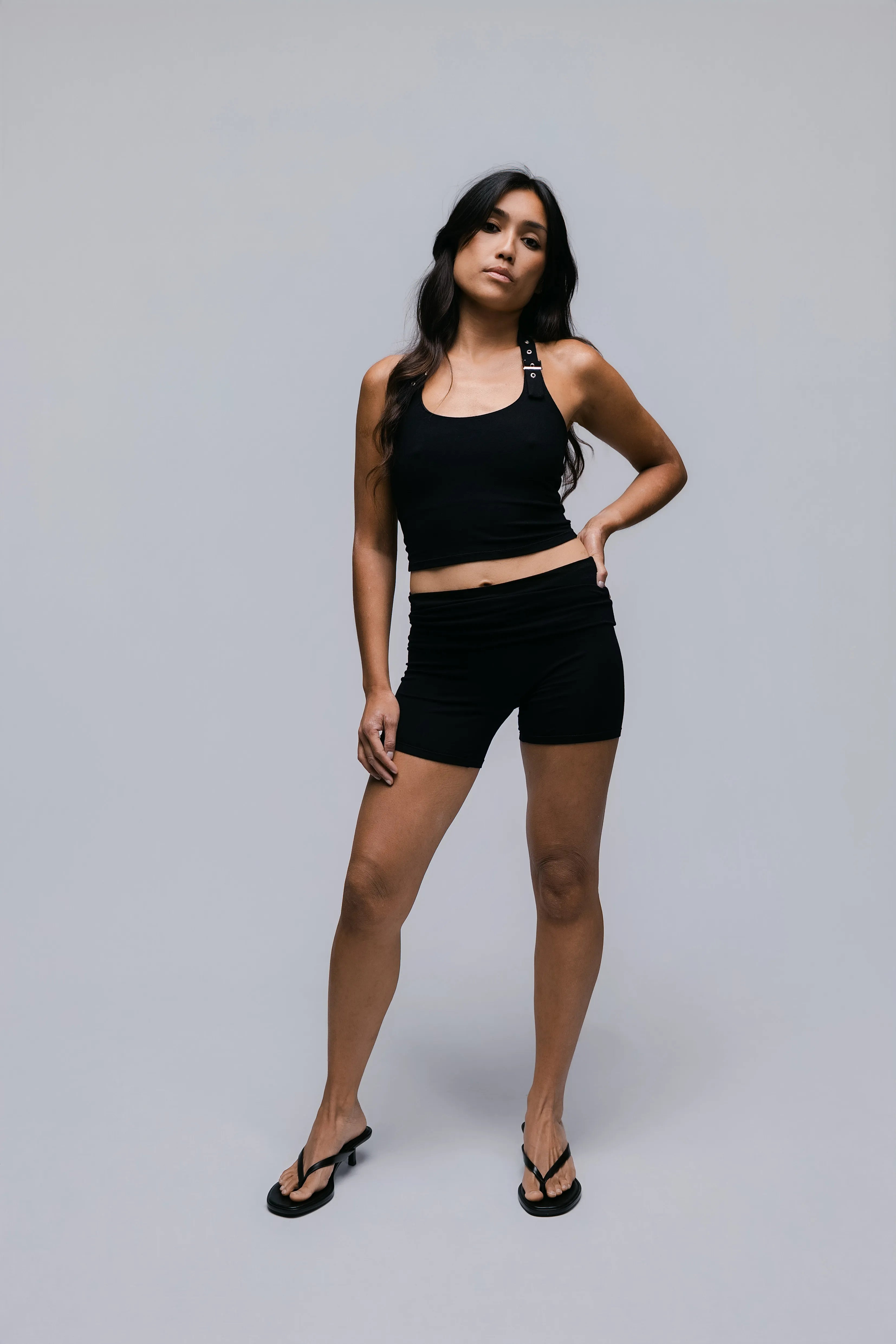 Model wearing the Billy Loop Sculpt Top in black, front view.