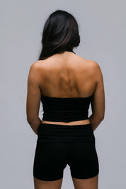 Model wearing the Billy Loop Sculpt Top in black, back view.