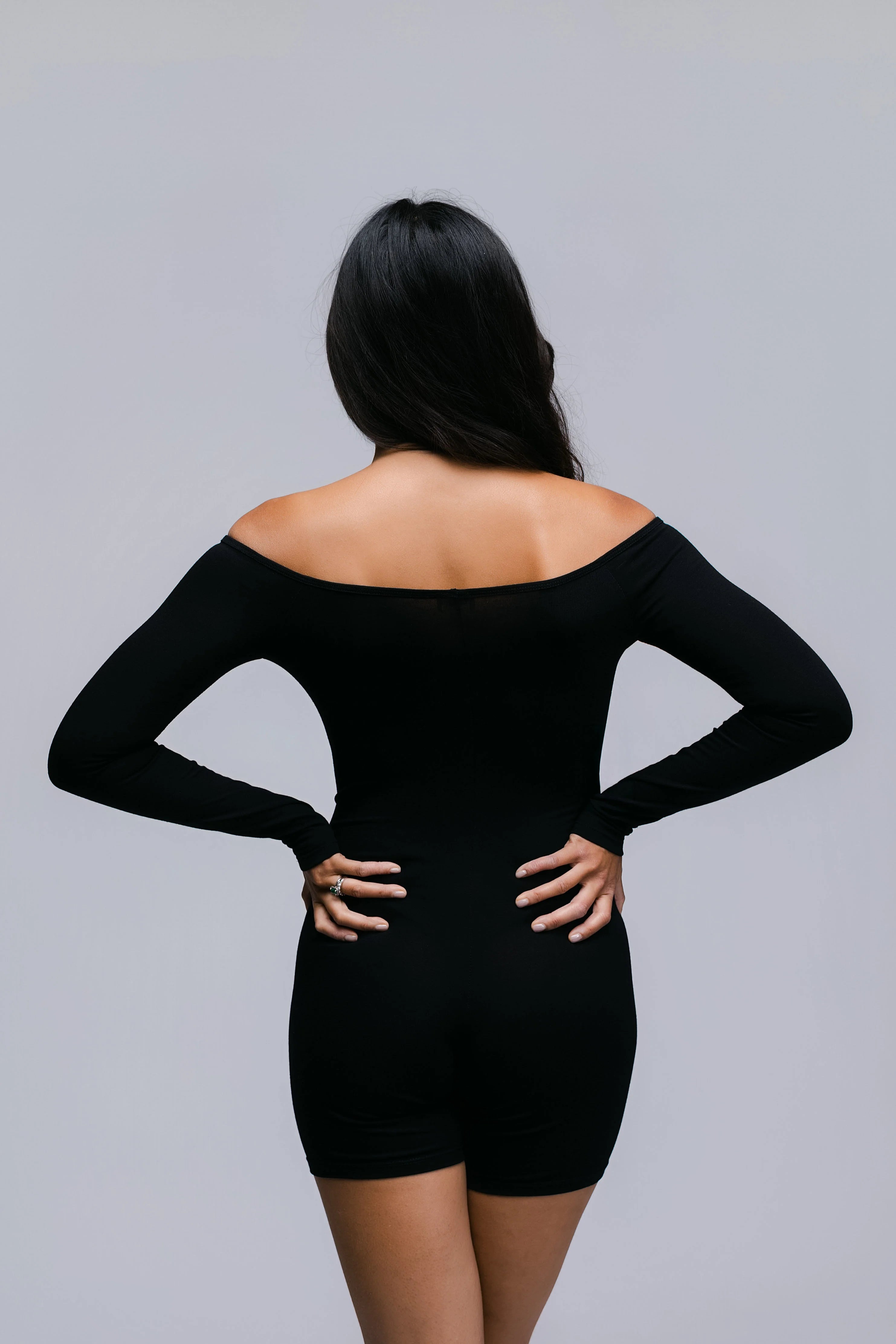 Model wearing the Billy Bardot Sculpt Suit in black, back view.