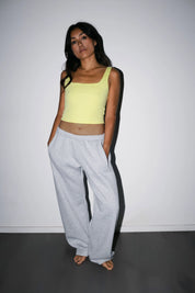 Model wearing the Billy Aura Tank in lemon, front view.