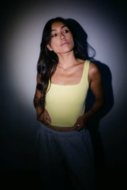 Model wearing the Billy Aura Tank in lemon, front view.