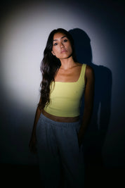 Model wearing the Billy Aura Tank in lemon, front view.